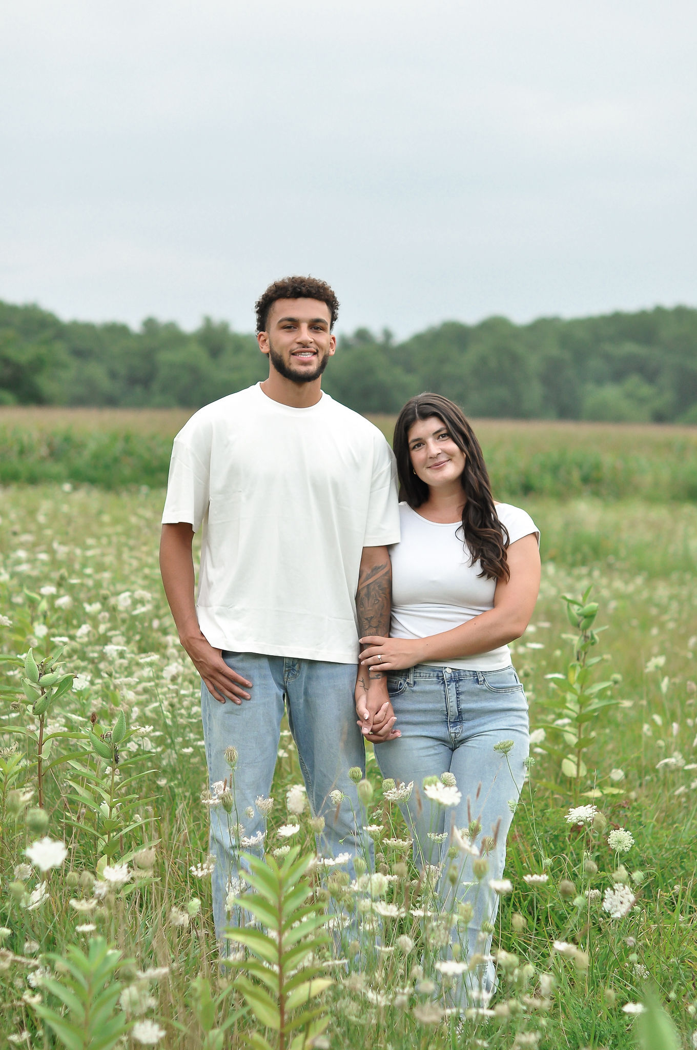Ellie and Jaiden smiling together in a field